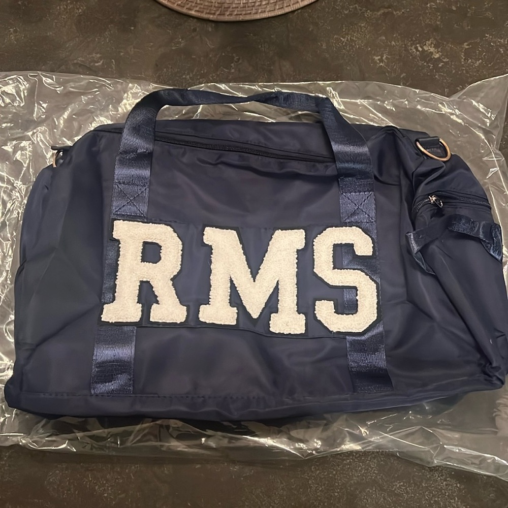 Judith March custom navy duffle bag.